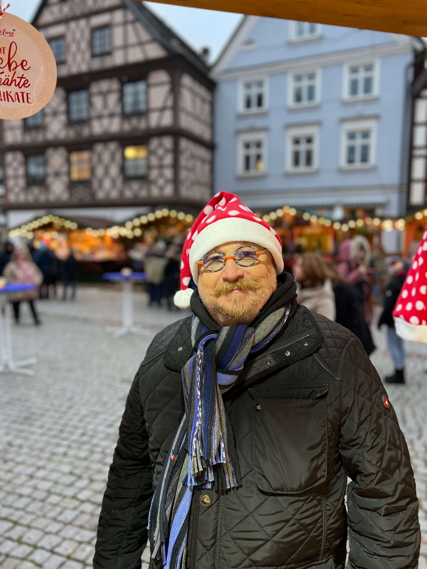 Besucher mit Tante-Ema-Weihnachtsmütze vor Fachwerk in Gengenbach